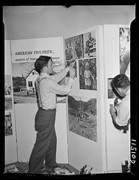 Washington, D.C. Milton Tinsley preparing the Faces of America exhibit at the National Folk Festival in Constitution Hall. Sourced from the Library of Congress.