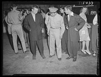Washington, D.C. Soldier inspecting a couple of "zoot suits" at the Uline Arena during Woody Herman's Orchestra engagement there. Sourced from the Library of Congress.