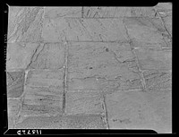 Texture background for motion picture and filmstrip titles. Flagstone paving detail. Sourced from the Library of Congress.