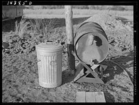 Trash container and fuel oil tank supplied to each trailer in camp. Trailer camp on U.S. 1 outside Alexandria, Virginia. Sourced from the Library of Congress.