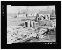 Concrete floor slabs, mud sills, and riser stools poured at central shop yard for farmers in Minnesota. Central construction permits economy in use of material. Minnesota. Sourced from the Library of Congress.