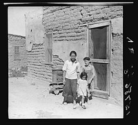 The mother said "I keep her dressed nice every day, because she is the only girl I've got." Great Western Sugar Company's beet sugar workers' colony at Hudson, Colorado. Sourced from the Library of Congress.