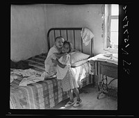 A girl of six who has full charge of her boy brother. Great Western Sugar Company's beet sugar workers' colony at Hudson, Colorado. It is due to the fact that her mother "works outside somewhere". Sourced from the Library of Congress.