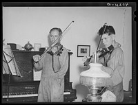 Barto, Berks County, Pennsylvania. Thomas Evans, a FSA (Farm Security Administration) client, giving a violin lesson to one of the neighbor's boys. Sourced from the Library of Congress.