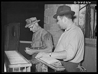 Lancaster County, Pennsylvania. Enos Royer and the poultry buyer figuring the cost of chickens by weight. The chickens brought 14 1/2 cents per pound. Sourced from the Library of Congress.