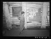 Shenandoah, Pennsylvania. A bulletin board at the foot of number one shaft in the Maple Hill colliery, showing a miner reading safety notices, Christmas greeting advertisements, etc.. Sourced from the Library of Congress.