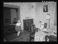 Shenandoah, Pennsylvania. Joe Gladski and two small daughters in the dining room at their home. He is a miner at Maple Hill. Sourced from the Library of Congress.