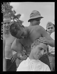 Camp Shelby, Hattiesburg, Mississippi. Getting a haircut. Sourced from the Library of Congress.