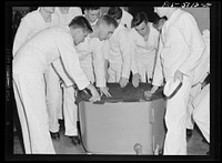U.S. Naval Academy, Annapolis, Maryland. Midshipmen receiving instruction about an engine. Sourced from the Library of Congress.