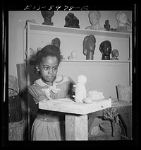 [Untitled photo, possibly related to: Teacher and girl modeling clay]. Sourced from the Library of Congress.