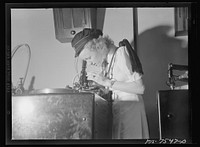 Washington, D.C. Foreign students at the international student assembly recording short talks in their native language to be broadcast by shortwave, after censorship by the Office of War Information (OWI), to Nazi-held territory. Filla and Toy, Norwegians, examining the cut in the recording through a microscope. Sourced from the Library of Congress.