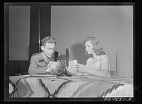 Washington, D.C. Foreign students at the international student assembly recording short talks in their native language, to be broadcast by shortwave, after censorship by the Office of War Information (OWI), to Nazi-held territory. Yolande Dankowier and Corporal Dziedzioch of Poland checking over their talks before recording. Sourced from the Library of Congress.