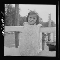 Detroit, Michigan. A Venetian night party at the Detroit yacht club, whose members represent the wealthier class of manufacturers and their friends. Little girl at the entrance to the yacht club. Sourced from the Library of Congress.