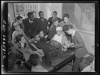 Benjamin Franklin High School, New York, New York. Boys take one day a week from their English course for "war activities" in order to learn the basic principles of first aid. Sourced from the Library of Congress.