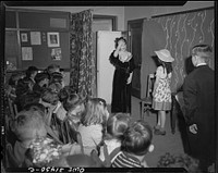 Schenectady, New York. Fourth grade students at the Oneida School presenting a play they have written from the book Heidi. The audience is composed of neighbor children and their parents; admission is five cents. The proceeds go to the American Red Cross. Sourced from the Library of Congress.