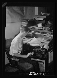 Keysville, Virginia. Randolph Henry High School. A student who runs a garage at night with his brother. Here he is seen working on his accounts. Sourced from the Library of Congress.