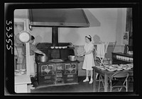 Keysville, Virginia. Randolph Henry High School. Kitchen of cafeteria. Lunches cost about fifteen cents. Students don't have much money and they bring produce from farms and receive tickets. Sourced from the Library of Congress.