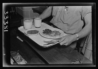 Keysville, Virginia. Randolph Henry High School. Cafeteria. Students don't have much money so they bring produce from farms for which they receive tickets. Lunches cost about fifteen cents. Typical lunch for fifteen cents: candied yams, macaroni and cheese, fruit salad, deviled eggs, dessert and milk. Milk is free and children have as much as they want. Sourced from the Library of Congress.