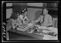 Keysville, Virginia. Randolph Henry High School. Mr. J. M. Garber, principal, working with two students on their next semester's schedules. Sourced from the Library of Congress.