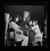 [Untitled photo, possibly related to: Washington, D.C. Graduate from Woodrow Wilson High School in June, this sailor is surrounded by girls when he returns from a visit]. Sourced from the Library of Congress.
