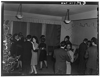 [Untitled photo, possibly related to: Washington, D.C. Decorating the tree at a Christmas Eve party given by Local 203 of the United Federal Workers of America, Congress of Industrial Organizations (CIO)]. Sourced from the Library of Congress.
