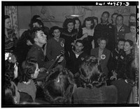 [Untitled photo, possibly related to: Washington, D.C. Pete Seeger, noted folk singer, leading the crowd in "When We March into Berlin" at the opening of the Washington labor canteen, sponsored by the United Federal Workers of American, Congress of Industrial Organizations (CIO)]. Sourced from the Library of Congress.