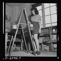 New York, New York. A young girl working on an oil painting during after school hours at Greenwich House, a community center where she receives day care while his mother works. Sourced from the Library of Congress.