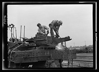 Boston and Maine railroad shops at Billerica, Massachusetts. Dismantling a railroad wrecking crane. Sourced from the Library of Congress.