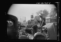 Manayunk, Pennsylvania. Workman at an automobile junkyard on Ridge Avenue. Sourced from the Library of Congress.