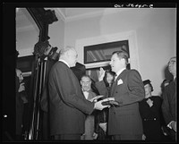 Justice Reed administering oath of office to Nelson A. Rockefeller, Assistant Secretary (American Republic Affairs), U.S. State Department. Sourced from the Library of Congress.