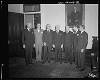 Secretary of State Edward Stettinius presenting new Under-Secretary of State Joseph C. Grew and five of the new assistant secretaries at the oath of office ceremonies. Left to right: William L. Clayton; Dean Acheson; Joseph C. Grew, Under-Secretary; Edward R. Stettinius, Secretary of State; Archibald MacLeish; Nelson A. Rockefeller; James C. Dunn. Sourced from the Library of Congress.