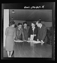 Chinese technical experts inspect reference material in University of Maryland library where they were taking courses offered by the UNRRA (United Nations Relief and Rehabilitation Administration) training center. From left: Miss Ing (from Far Eastern Division, UNRRA Washington  office); H.W. Li; .P.C. Chao; Miss Eleanor Hindler (special consultatnt, ILO office, Montreal, who is acting as coordinator of the course for Chinese technical experts at UNRRA training center); and C.C. Yeh. Sourced from the Library of Congress.