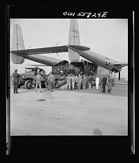 United States Army Air Forces newest transport and most promising for airborne operations. Its specific function is to land heavy military loads safely on rough fields near battle points. First war plane designed solely for hauling military cargo. May be used to carry troops, paratroops,  and equipment up to the size fo tanks. Shown at demonstration of equipment held by United States Army Air Forces. Sourced from the Library of Congress.