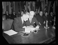 Washington, D.C. Henri Bonnet, French Ambassador, signing the United Nations declaration for France at the State Department. Sourced from the Library of Congress.