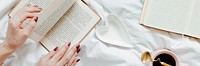 Woman reading a novel on her bed on a Sunday afternoon