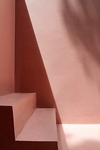 Steps by a pink wall with shadows