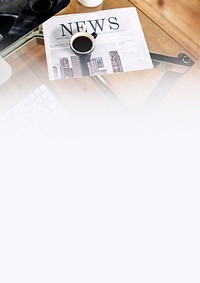 Laptop and a newspaper on a desk