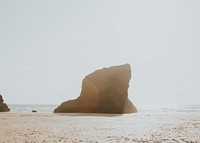 Sun shining on big rock on the beach