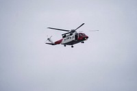 Coastguard helicopter flying over the sea in Scotland