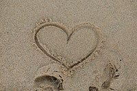 Drawing heart on the beach