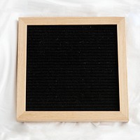 Blank wooden frame on a white sheet