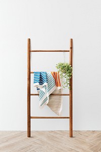 Towel and a plant hanging on a wooden ladder mockup 