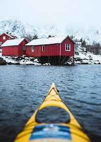Woman paddling the kayak in Lofoten, Norway
