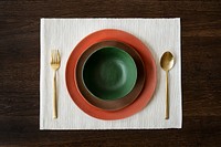 Colorful dinnerware set on a wooden table aerial view