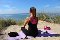 Free woman doing a yoga pose on beach image, public domain sport CC0 photo.