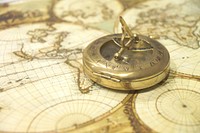 Golden compass on map, free public domain CC0 image.