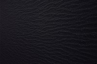 Black volcanic sand background, free public domain CC0 photo.