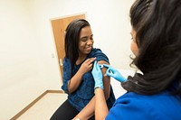 A doctor placing a bandage on the injection site of a patient. Original image sourced from US Government department: Public Health Image Library, <a href="https://www.rawpixel.com/search/cdc?sort=curated&amp;page=1">Centers for Disease Control and Prevention</a>. Under US law this image is copyright free, please credit the government department whenever you can&rdquo;.