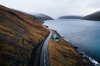 Scenic country road by the lake on Faroe Islands background
