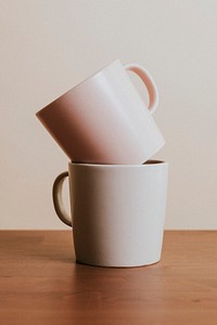 Earth tone color ceramic coffee cups on wooden table